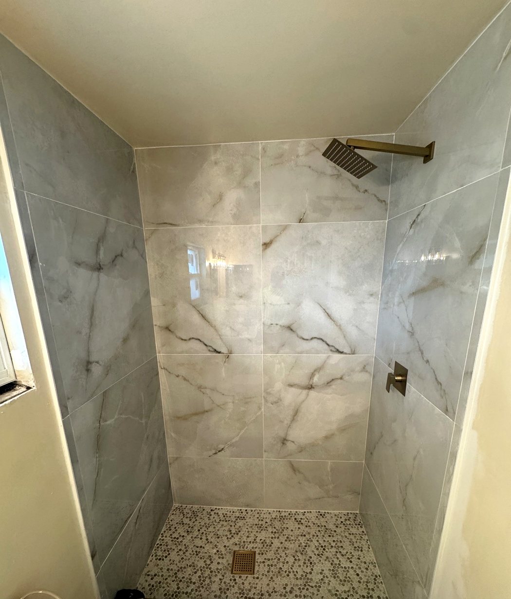 Walk-in marble tile shower